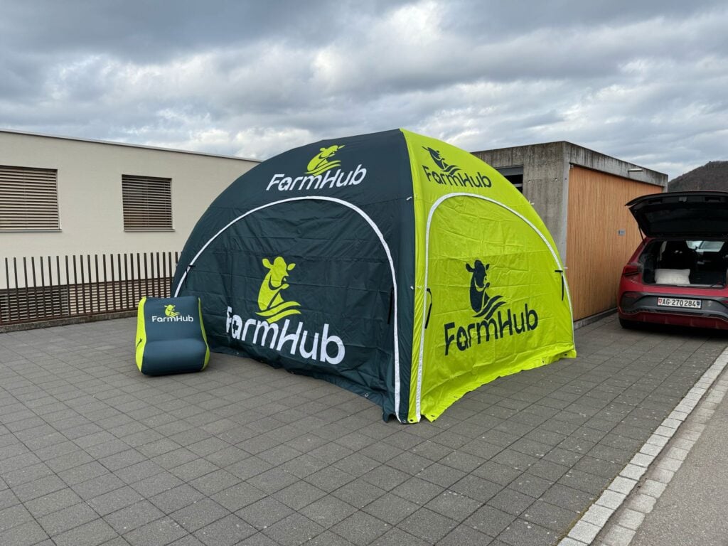 Inflatable event tent framing a stage for a product launch