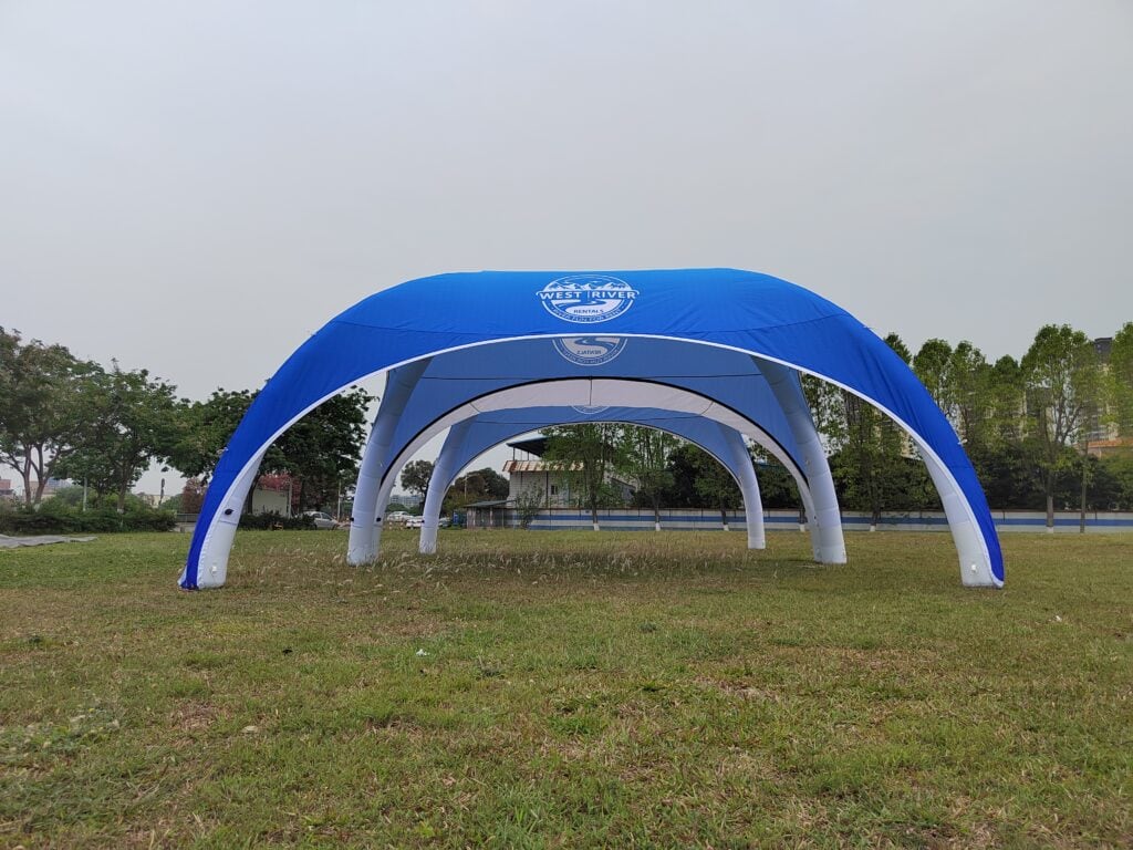 Blue inflatable arch with corporate logo on grass
