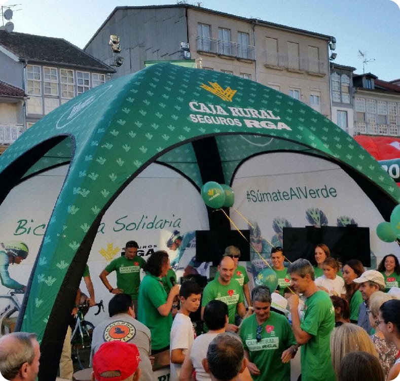 Branded inflatable dome and teardrop flags at a mass-participation cycling event