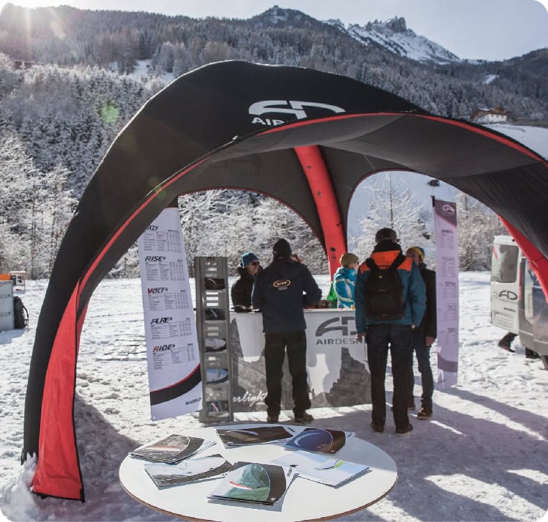 Printed inflatable dome pitched on snow at a mountain ski area